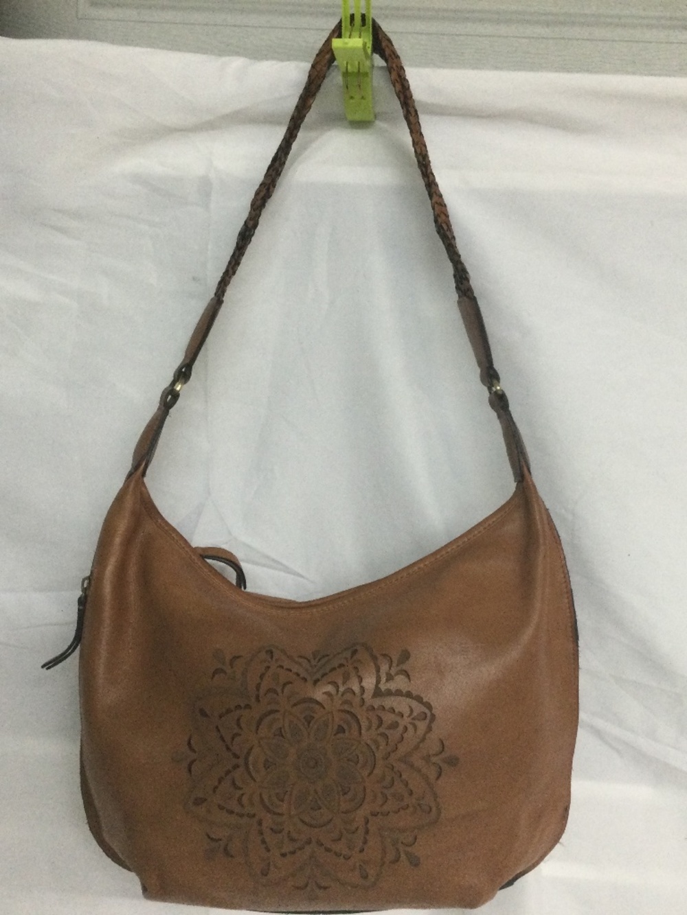 Brown Leather Hobo Bag with Laser-Cut Floral Pattern.
